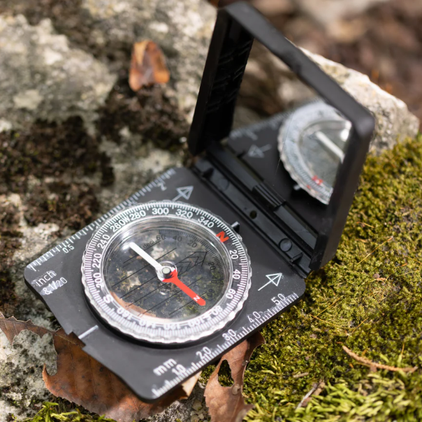 Compass on a rock with a natural background